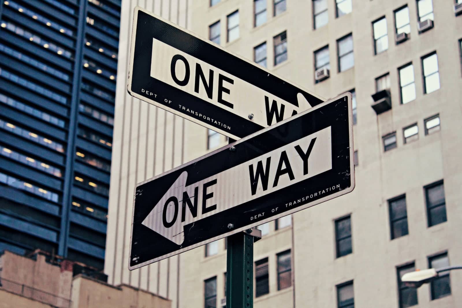 Direction arrows showing a One Way sign pointing in two directions depicting various Investment Opportunities in Dubai.